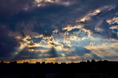 Silhouette cityscape against sky during sunset