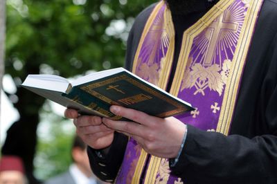 Cropped image of man holding book