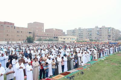 Crowd at town square against clear sky