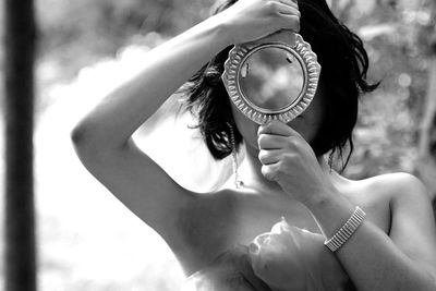 Close-up of woman holding mirror