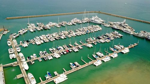 High angle view of sailboats moored at harbor