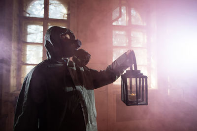 Man photographing through window