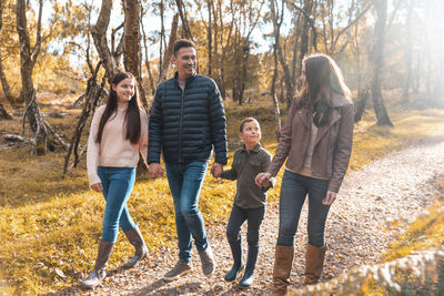 Group of people standing in park during autumn