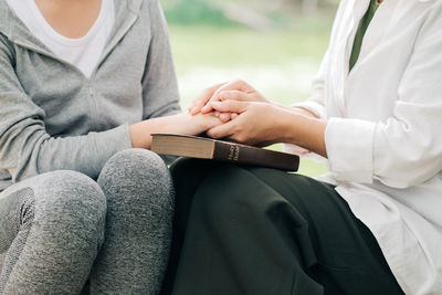 Midsection of couple holding hands