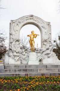 Low angle view of angel statue against sky