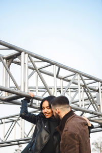 Happy couple standing under sky outdoors