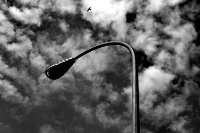 Low angle view of street light against cloudy sky
