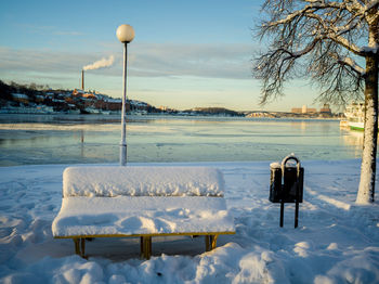 Snow on shore against sky during winter