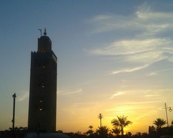 Low angle view of tower against sky at sunset