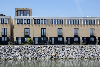 Building by rocks against clear sky