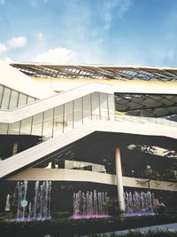 Low angle view of bridge over buildings against sky