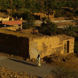 Woman in front of built structure