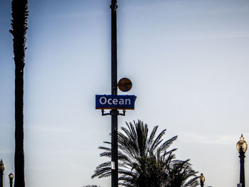 Low angle view of sign board against sky