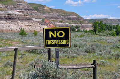 Information sign on land against sky