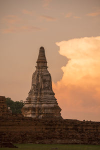 Low angle view of wat mahathat against sky during sunset
