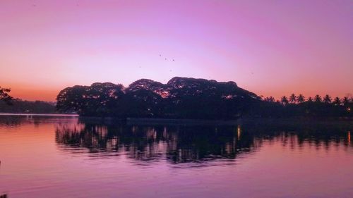 Scenic view of lake against sky at sunset