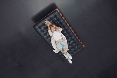 High angle portrait of woman lying on mattress