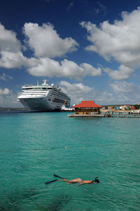 Boats in sea against blue sky