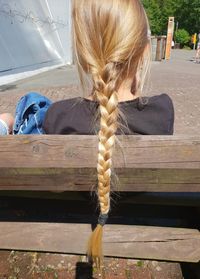 Rear view of girl sitting on bench