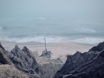 Scenic view of sea and mountains against sky