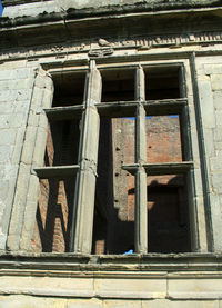 Low angle view of window on old building