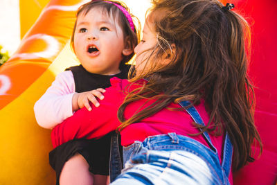 Close-up of sisters on bouncy castle