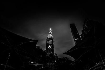 Low angle view of clock tower at night