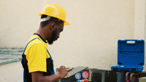 Side view of man working at construction site