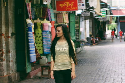 Woman walking on footpath in market