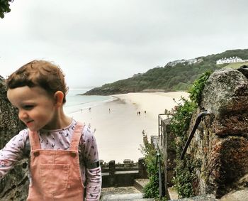 Little girl standing in lake