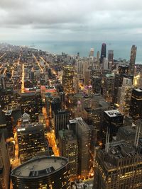 High angle view of illuminated city buildings against sky