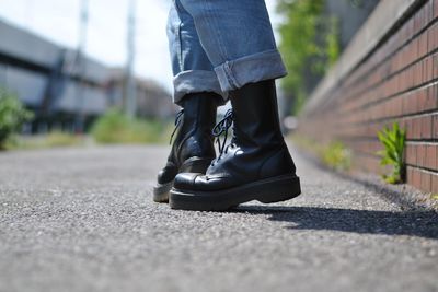 Low section of man walking on zebra crossing