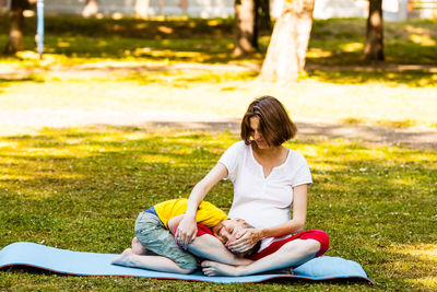 Full length of girl sitting on field