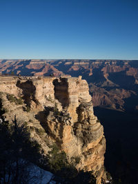 Scenic view of canyons against clear blue sky