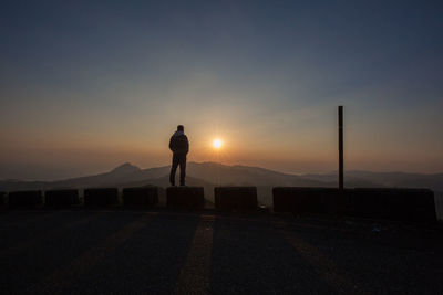 Man standing against sky during sunset