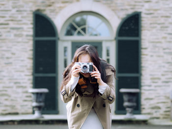 Portrait of young woman standing outdoors