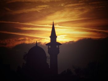 Silhouette of church against sky