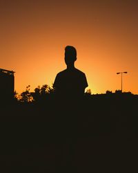 Silhouette man against clear sky during sunset