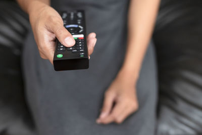Midsection of man using mobile phone