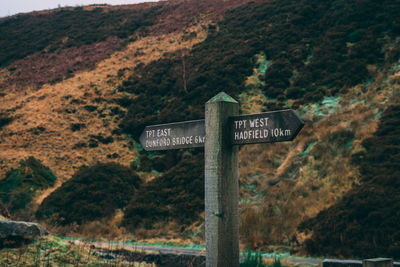 Information sign on road by mountain