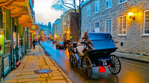 Cars on illuminated street in city at night