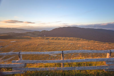 Scenic view of field against sky during sunset