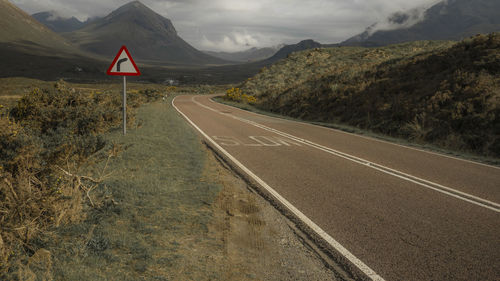 Road amidst mountains against sky