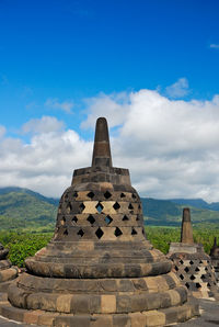 Ruins of temple against cloudy sky