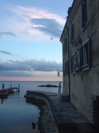 View of calm sea with buildings in background