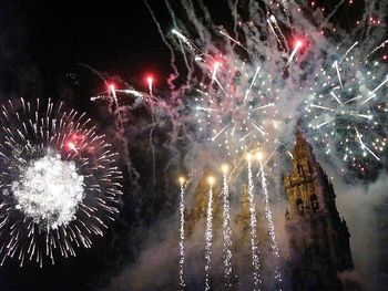 Low angle view of firework display at night