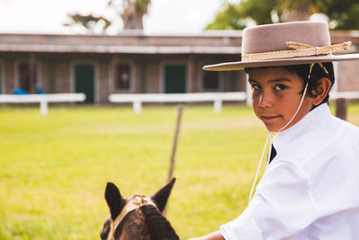 Close-up portrait of a kid riding horse