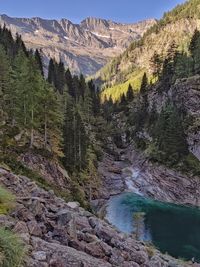 Scenic view of river amidst mountains against sky