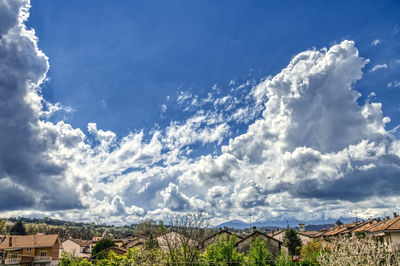 Scenic view of townscape and mountains against sky