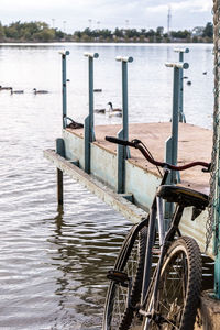 Abandoned bicycle on the pier, also abandoned, from a lagoon